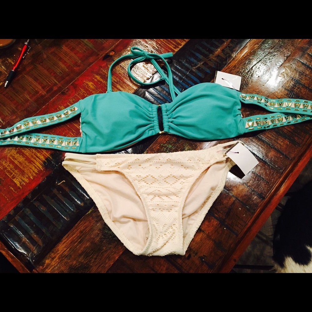 Swimsuit with beads, stitching, and gold accents.